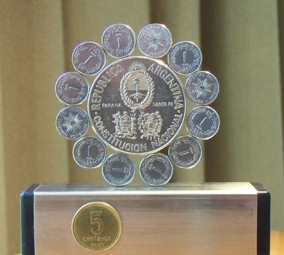 image:   Standing dodecagonal   rose / mandala of coins of  Argentina  and Uruguay (centre: 5 pesos 1994 Argentina, ring: Uruguay 1 peso 1989)         